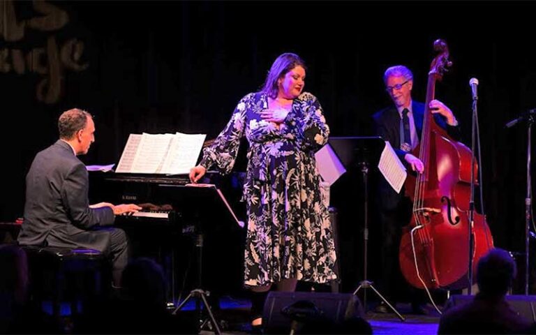 female singer on stage with pianist and bass player at arts garage delray beach