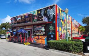 front exterior of colorful arcade building with murals at silverball retro arcade delray beach