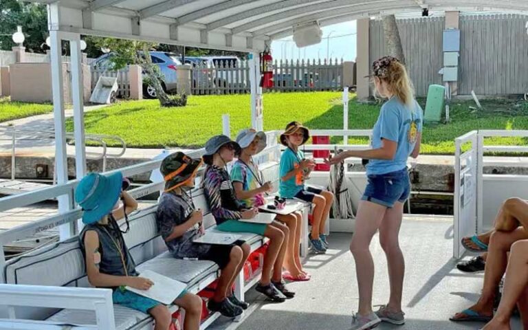 guide talking to group of kids on boat at florida water tours st augustine