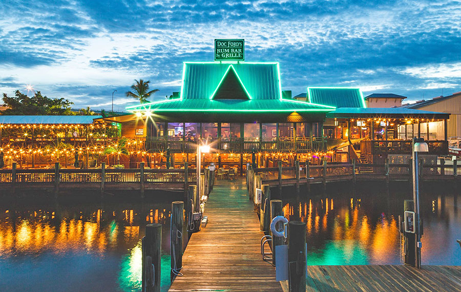 long exposure view of front of restaurant with dock and bay at night doc fords rum bar grill fort myers