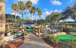 mini golf course with palms and animal sculptures at adventure landing st augustine