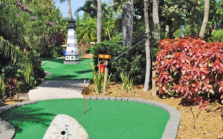 mini golf green with lighthouse statue at puttin around delray beach