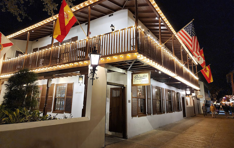 night front exterior along lighted street with flags at columbia restaurant st augustine