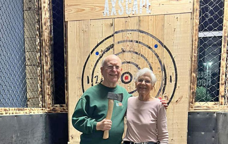 older couple posing with axe target at xscape our rooms st augustine