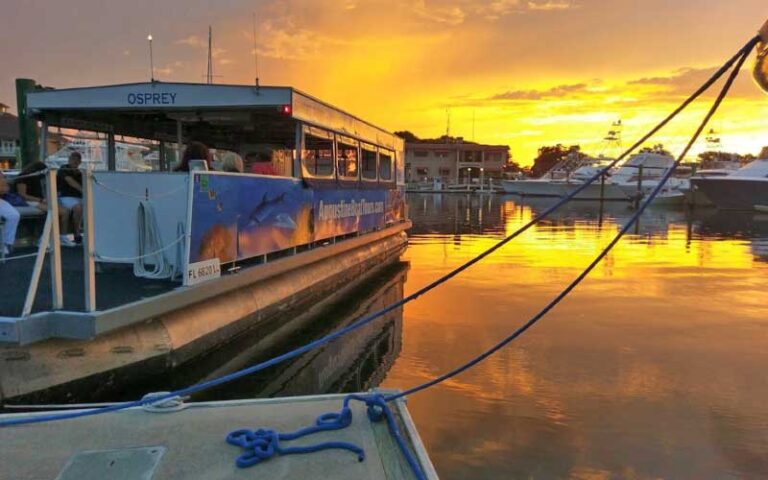 pontoon style boat moored with sunset sky at florida water tours st augustine