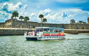 pontoon style tour boat with castillo de san marcos at florida water tours st augustine