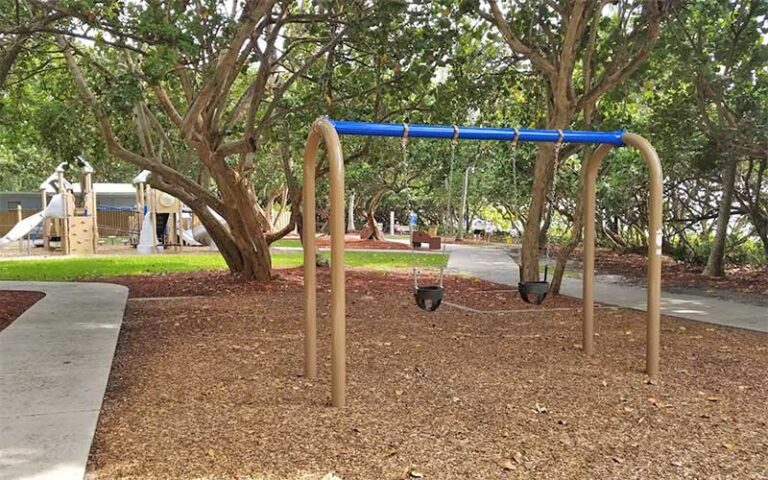 swing set and playground under shady trees at gulfstream park delray beach