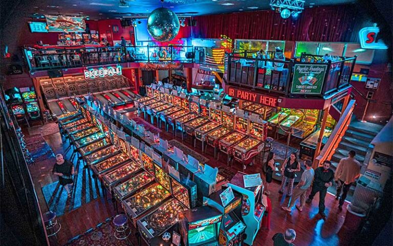 view from loft of large arcade with rows of games at silverball retro arcade delray beach