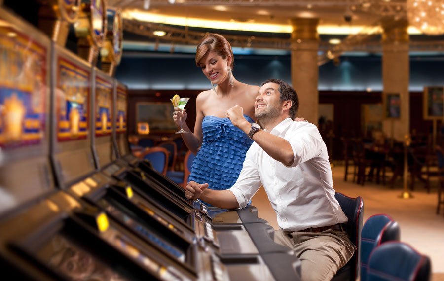 well dressed man and woman playing the slot machine at seminole hard rock casino