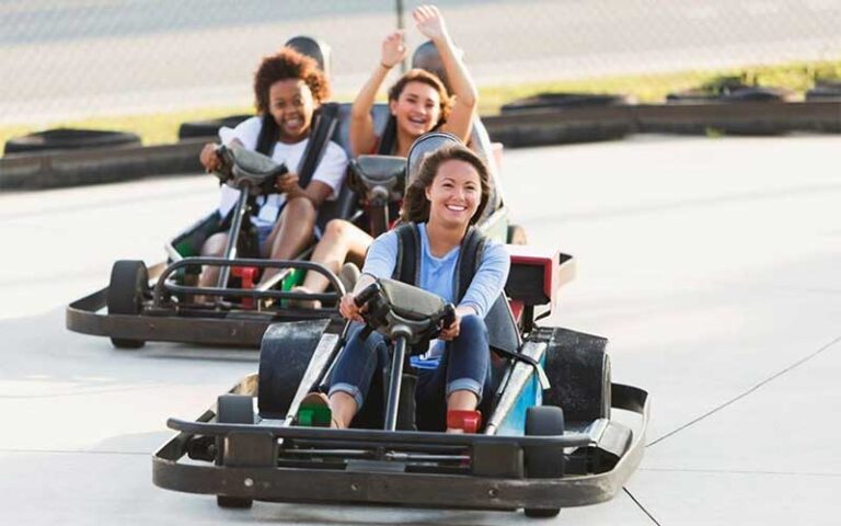 young ladies racing go karts along track at adventure landing st augustine