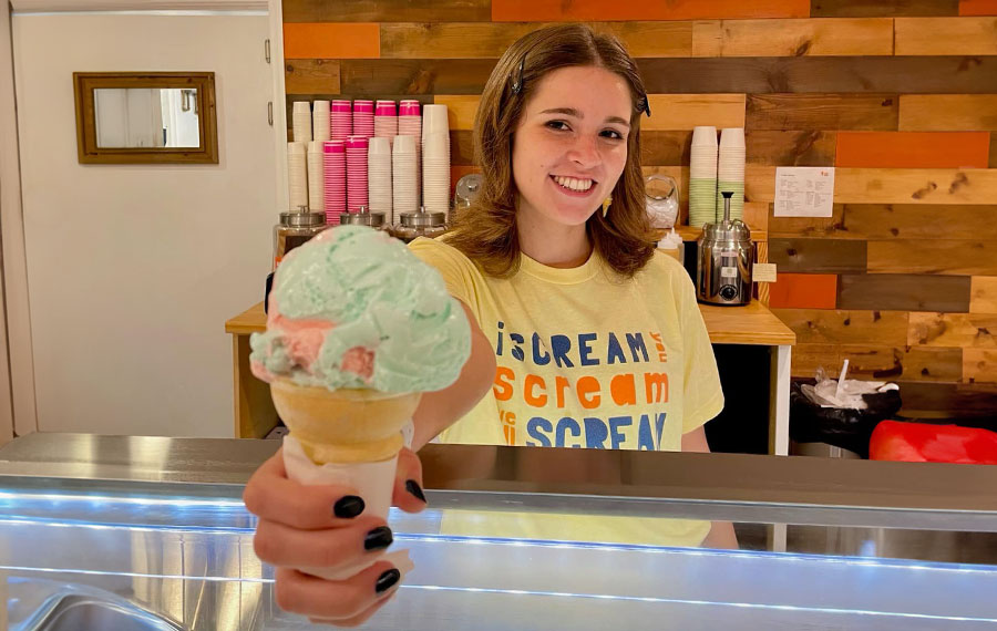 young lady behind counter serving ice cream cone orange octopus siesta key sarasota