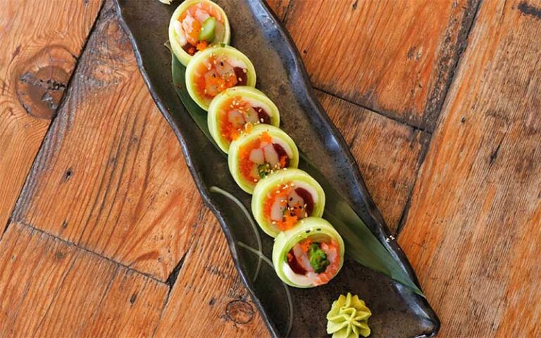 avocado wrapped sushi roll on rectangular plate at lemongrass asian bistro delray beach