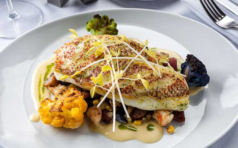 baked fish fillet entree with garnish at latitudes at delray sand resort highland beach