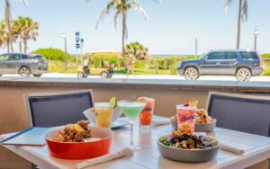 beach view patio table setting with entrees at bostons on the beach delray beach