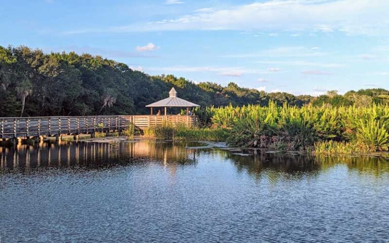 boardwalk pavilion over lake with treeline at green cay nature center wetlands boynton beach