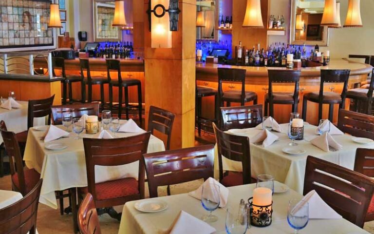 dining room interior with wood bar and seating at tramonti delray beach