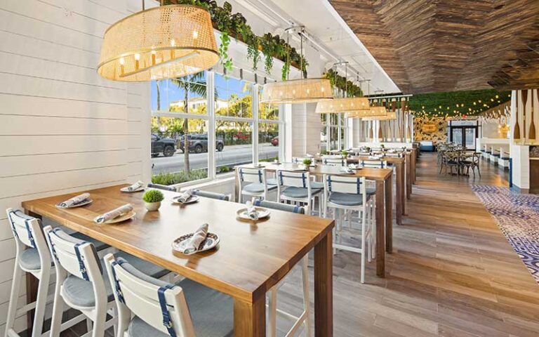 dining with windows and pendants at the hampton social delray beach