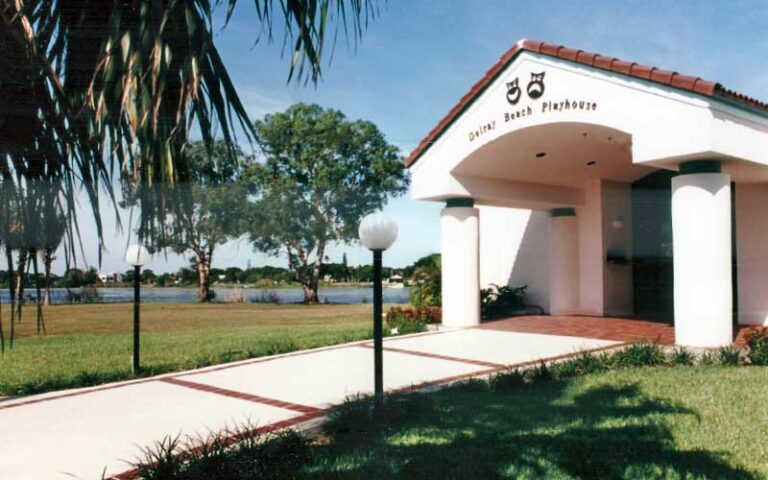 exterior of theater entrance with lake park at delray beach playhouse