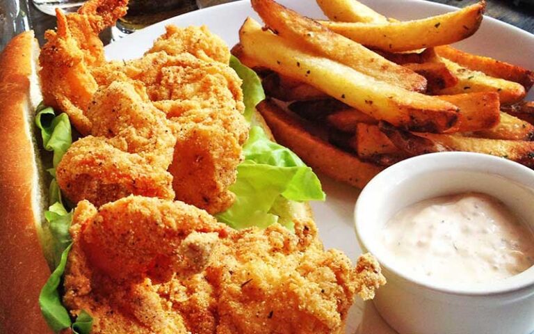 fried shrimp po boy with sauce and fries at park tavern delray beach