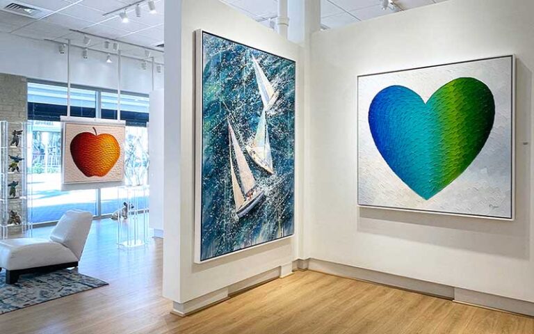 heart and apple paintings on exhibit walls at blue gallery delray beach