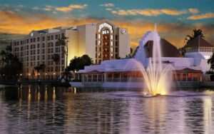 hotel view across water with fountain and dusk sky at hilton boca raton suites