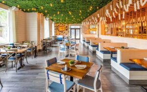 large dining area with booths and tables at the hampton social delray beach