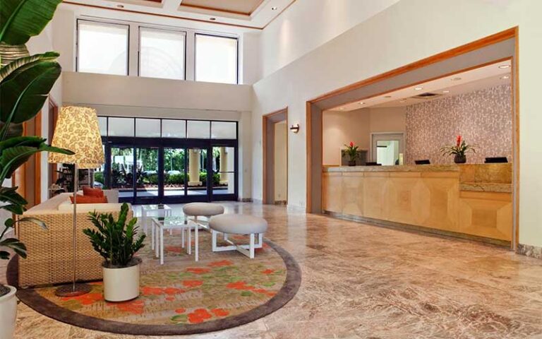 lobby with front desk and entrance at hilton boca raton suites