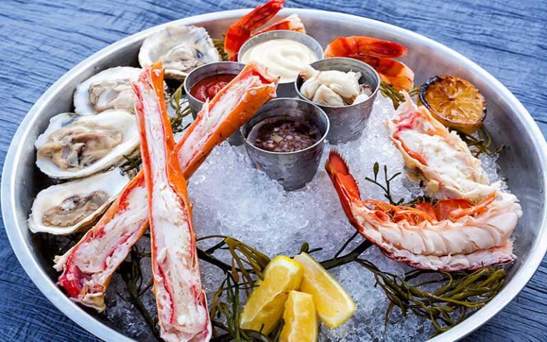 metal platter with seafood sampler and sauces at latitudes at delray sands resort highland beach