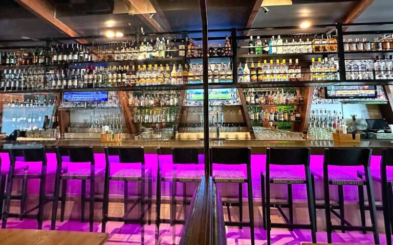 purple lighted bar with liquor bottles at lemongrass asian bistro delray beach