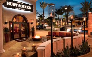 restaurant exterior at night with seating and lights at burt maxs delray beach