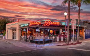 street corner exterior with sunset sky at johnnie browns delray beach