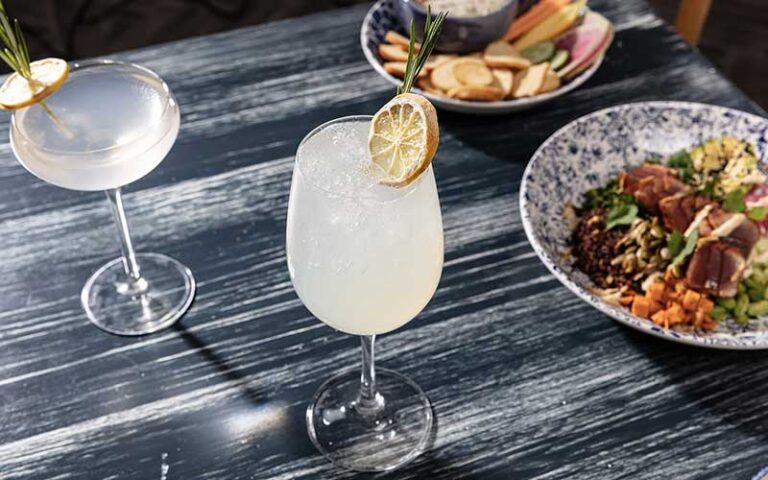 table with entrees and cocktail at the hampton social delray beach