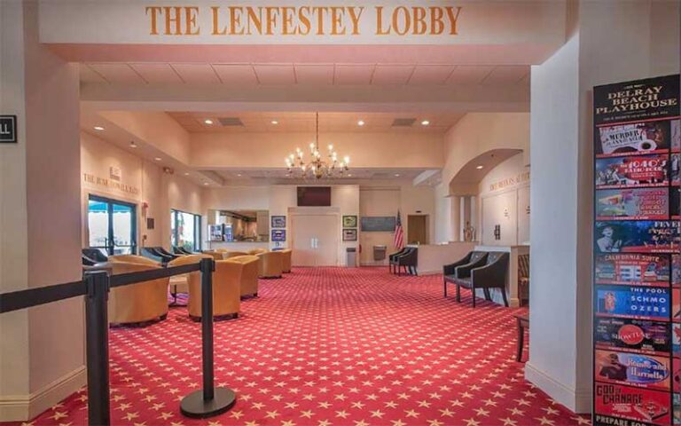 theater lobby with red carpet and signs at delray beach playhouse