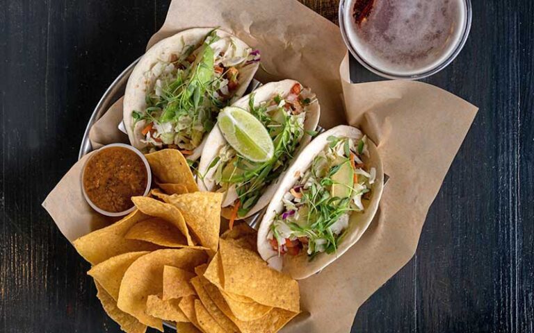 three fish tacos with sides in tray at johnnie browns delray beach