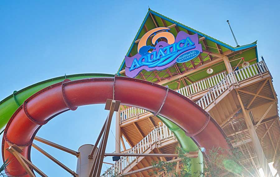 view looking up at water slide tower with sign aquatica orlando