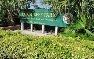 wooden park sign in hedge at patch reef park boca raton