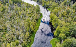 aerial view of dense wetland with airboat on canal at tom jerrys airboat rides ocala orlando