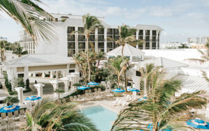 aerial view of high rise hotel with pool area at opal grand resort spa delray beach