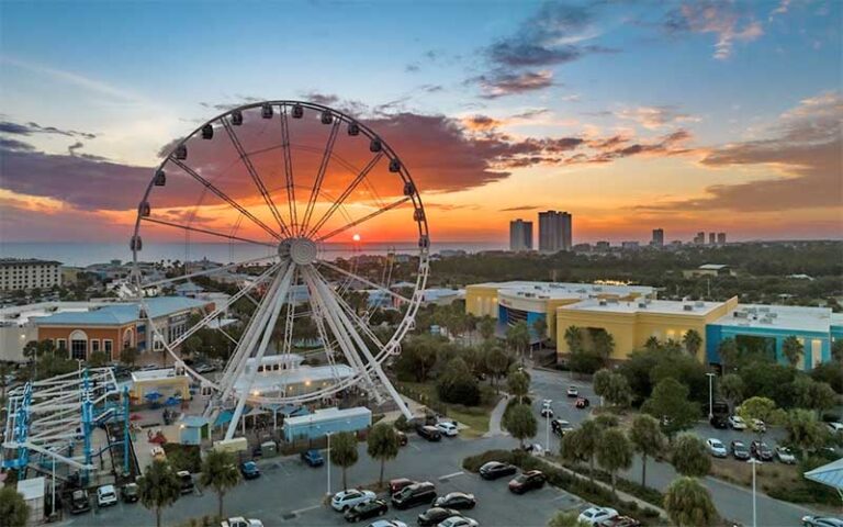 aerial view of park with ferris wheel and sunset background at skywheel at pier park panama city beach