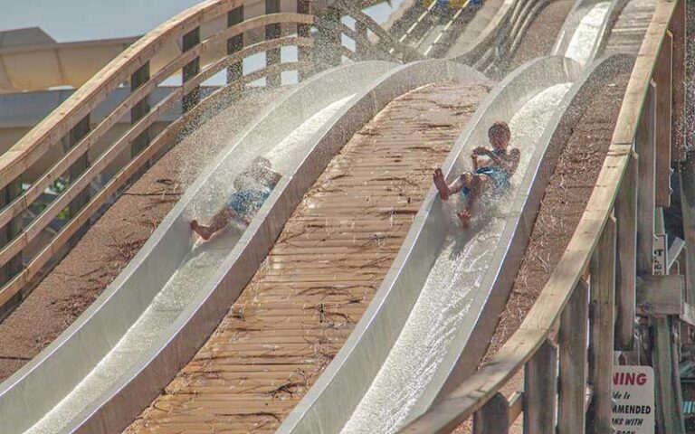 boys zooming down water slides at shipwreck island waterpark panama city beach