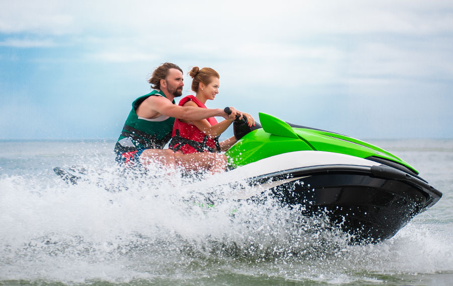 couple riding splashy green jet ski on florida lake