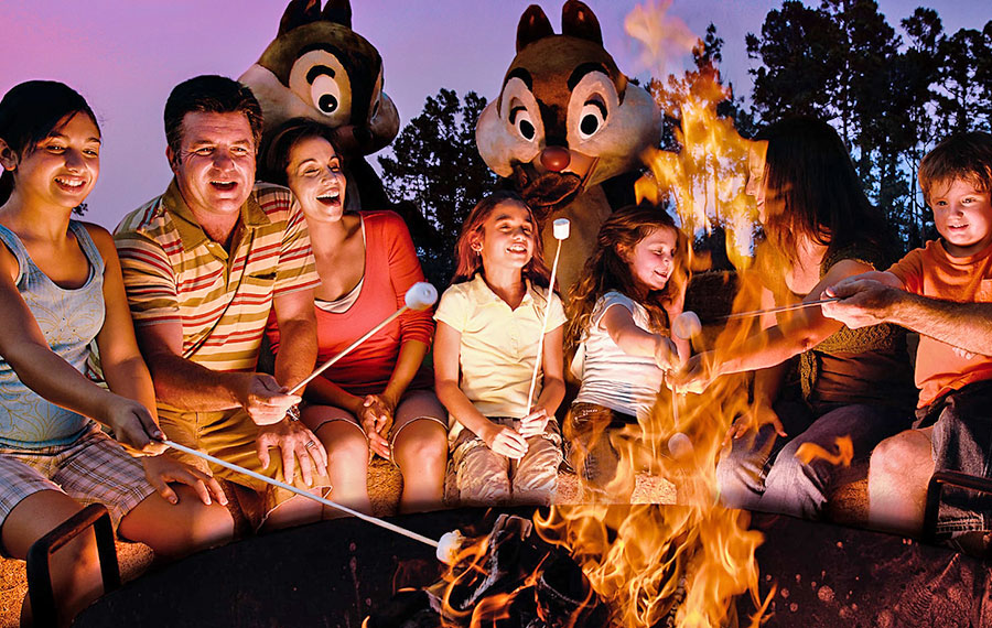 families roasting marshmallows over fire at chip n dales campfire sing a long fort wilderness resort disney world