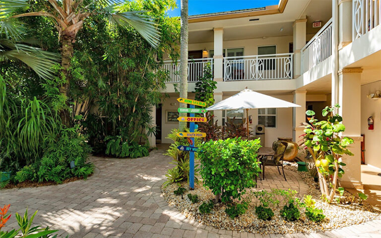 inner courtyard with signs and patio at cranes beach house boutique hotel luxury villas delray beach