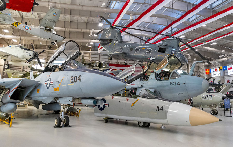 interior of hangar with multiple military aircraft displayed at national naval aviation museum pensacola