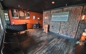 interior of lobby with room posters and desk at the ocala escape