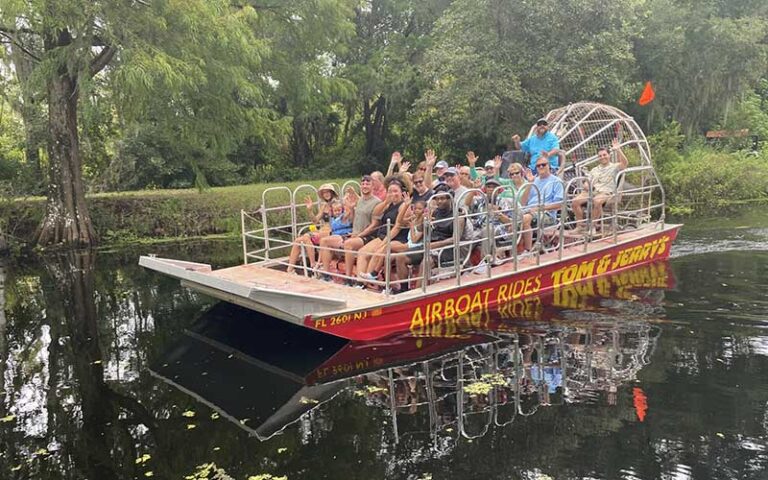 large tour group riders on airboat along canal at tom jerrys airboat rides ocala orlando