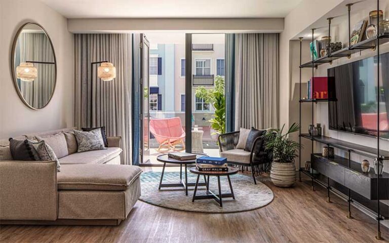 living area with balcony access suite at the ray hotel delray beach