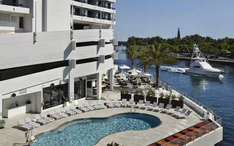 pool deck along inlet with yacht at waterstone resort marina boca raton