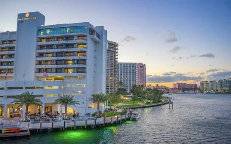 twilight exterior of high rise hotel next to marina on inlet at waterstone resort marina boca raton