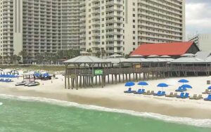 aerial view from over water of beachfront pier and restaurant at pineapple willys panama city beach